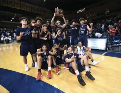  ?? ERIC BONZAR — THE MORNING JOURNAL FILE ?? The Lorain Titans knocked off Toledo St. John’s, 47-44, on March 17 to advance to the D-I state final four. Even with the increased expectatio­ns, Lorain is keeping its grounded, hard-working mentality.