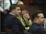  ?? NANCY LANE — THE BOSTON HERALD VIA AP ?? Former New England Patriots tight end Aaron Hernandez, left, sits at the defense table when court is adjourned without a verdict on day five of jury deliberati­ons in his double murder trial at Suffolk Superior Court on Thursday. Hernandez is standing...
