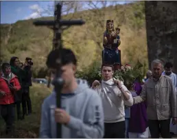  ?? EMILIO MORENATTI – THE ASSOCIATED PRESS ?? Those who pray in Spain hope for some rain: Local residents take part in a procession carrying a statue of the Our Lady of the Torrents, a virgin historical­ly associated with drought, in l'Espunyola, north of Barcelona, Spain, Sunday.