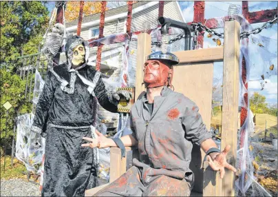  ?? GREG MACNEIL/CAPE BRETON POST ?? Shawn Henry, left, known over the Halloween season as the Grimm Preacher, and Jeff Peach show off the faux electric chair created for the Westside Cemetery Halloween haunt in Westmount. The haunt will not run this year and Peach and his fellow haunters...