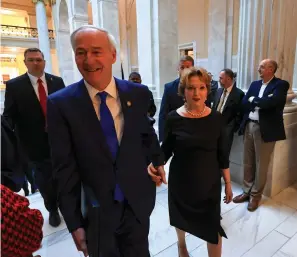  ?? Staton Breidentha­l/The Arkansas Democrat-Gazette ?? ■ Gov. Asa Hutchinson and first lady Susan Hutchinson arrive Monday at the House Chamber in Little Rock shortly before the governor delivered his state of the state speech.