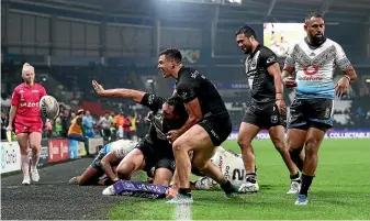  ?? GETTY IMAGES ?? Kiwi players celebrate after Jordan Rapana scores a try in the final minute to confirm New Zealand’s World Cup quarterfin­al win over Fiji in Hull.