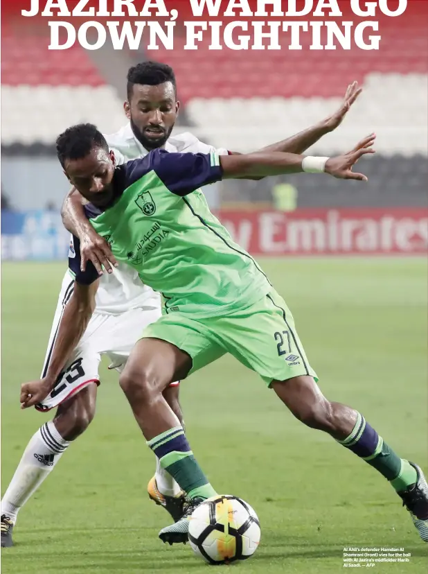  ?? AFP ?? Al Ahli’s defender Hamdan Al Shamrani (front) vies for the ball with Al Jazira’s midfielder Harib Al Saadi. —