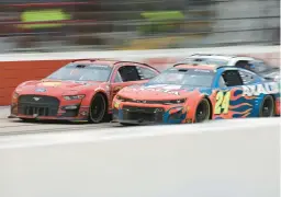  ?? JAMES GILBERT/GETTY ?? Joey Logano and William Byron (24) drive side by side during Sunday’s NASCAR race. Logano sent Byron into the wall on the next-to-last lap en route to the victory.