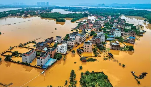  ?? — AFP ?? Flooded buildings and streets after heavy rains in Qingyuan in southern China’s Guangdong province on Monday.
