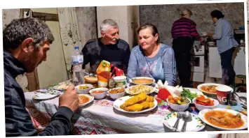  ?? ?? Shelter: Svetlana, centre, with fellow villagers in her basement