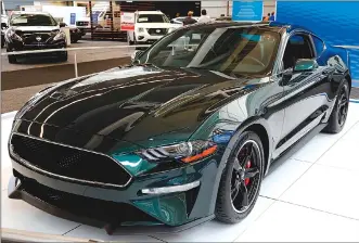  ?? Associated Press photos ?? This file photo shows a 2019 Ford Mustang Bullitt on display at the Pittsburgh Auto Show. For 2019, Ford will debut the latest Bullitt version of the Mustang, paying homage to the fearless chase car from the 1968 Steve McQueen movie.