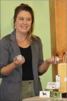  ??  ?? Rebecca Lawson, a sales associate for Charlotte’s Web products, showcases the hemp infused balm which features beneficial botanicals to help support healthy-looking skin and beautifica­tion according to the company website.