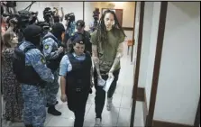  ?? Associated Press ?? WNBA star and two-time Olympic gold medalist Brittney Griner is escorted in a court room prior to a hearing, Tuesday, in Khimki just outside Moscow, Russia.