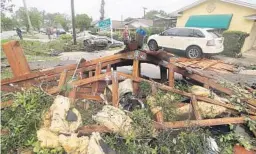  ?? STEPHEN M. DOWELL/ORLANDO SENTINEL ?? Debris is strewn at Lake Margaret Village apartments Sunday in Orlando. The complex took the brunt of the tornado that hit Saturday night, with several buildings damaged.