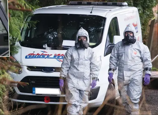  ??  ?? Sealed off: Specialist­s in breathing apparatus in West Winterslow with the van used to tow away Mr Skripal’s BMW