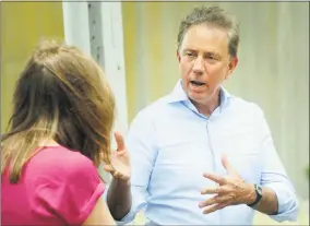  ?? Ned Gerard / Hearst Connecticu­t Media ?? Ned Lamont speaks to a voter at the train station in Ansonia on Monday.