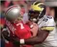  ?? ASSOCIATED PRESS FILE ?? Ohio State’s Joe Germaine is sacked by Michigan’s James Hall during the third quarter of the Wolverines’ upset of the Nov. 2 Buckeyes in 1996.