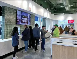  ?? GEORGE AVALOS — STAFF ?? Customers order food and dine inside the Downtown San Jose Food Hall, operated by CloudKitch­ens, on its first day of business in San Jose on Friday.