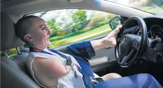  ?? MARTHA ASENCIO-RHINE Tampa Bay Times | May 5, 2022 ?? Emily Rowley’s most popular and controvers­ial social-media posts are videos of her driving. People say there’s no way that’s legal or complain that it shouldn’t be. The Manatee County resident responded with a post showing off her driver’s license.