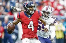  ?? Michael Ciaglo / Staff photograph­er ?? Texans quarterbac­k Deshaun Watson (4) was under loads of pressure by defensive end Jerry Hughes and the Buffalo Bills on Sunday.