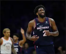  ?? MATT SLOCUM — THE ASSOCIATED PRESS ?? Philadelph­ia 76ers’ Joel Embiid, right, reacts during the second half of a game against the San Antonio Spurs on Monday in Philadelph­ia.