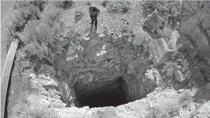  ??  ?? ABOVE: Nick Castleton looks down a mineshaft near Eureka, Utah, in September. Underneath the landscape of the U.S. West lie hundreds of thousands of abandoned mines, an undergroun­d world that can hold serious danger and unexpected wonder.