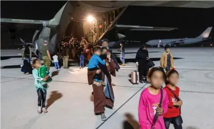  ?? Photograph: LACW Jacqueline Forrester/Department of Defence ?? Evacuees from Afghanista­n disembark a British C-130 at an Australian military base in the Middle East. The 76 passengers then boarded a chartered aircraft to Perth.