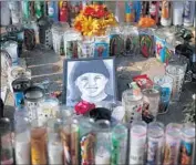  ?? Justin Sullivan Getty Images ?? A PICTURE of Andy Lopez sits among candles and gifts at a memorial on Oct. 29, 2013, in Santa Rosa.