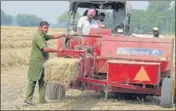 ?? HT FILE ?? Farmers using a baler machine to manage paddy straw in a Punjab village.