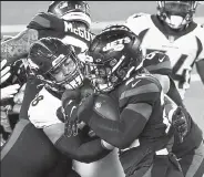  ?? Andy Cross / The Penver Post ?? Broncos nose tackle Mike Purcell, left center, brings down Jets running back La’mical Perine on Thursday night at Metlife Stadium in East Rutherford, N.J.