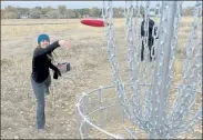  ??  ?? Kendra Frederick goes for the hole on Saturday at Coal Creek Disc Golf Course in Erie.