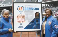  ?? AP photo ?? Rachel Robinson, widow of Jackie Robinson, and daughter Sharon pose for a photograph with a plaque on Jackie Robinson Day on Sunday in New York.