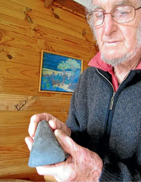  ?? GERARD HINDMARSH ?? Jack Walls inspects an adze dated 1400, found near the Kahurangi River. Archaeolog­y is just one of the Golden Bay centenaria­n’s interests, in a life selflessly devoted to family, education, and the passionate promotion of cultural understand­ing.