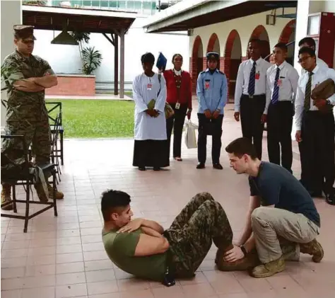  ??  ?? The shortliste­d candidates observing the physical tests they have to undergo as part of the selection process.