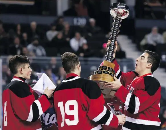  ?? BRITTON LEDINGHAM ?? Regina Pat Canadians captain Adam Herold, right, hoisted the Mac’s midget hockey tournament trophy in Calgary on Jan. 1. Herold was killed in Friday’s bus crash.