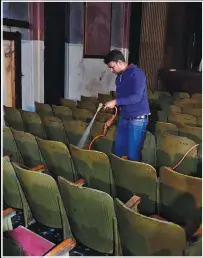  ?? ?? Bangladesh­i volunteer and actor Shuman Dali, 39, washes chairs Feb. 16 before attending a rehearsal for a play at Empire Cinema.