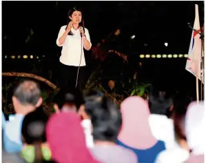  ?? — Filepics ?? Constratin­g campaigns: Wong (left) addressing a ceramah and Tsen meeting a voter. While Wong speaks with crowds, Tsen reaches out to individual voters.