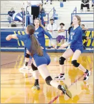  ?? Westside Eagle Observer/MIKE ECKELS ?? Heaven McGarrah’s (center) dive toward the ball pays off as she is able to use a forearm hit to send the ball back over the net during the second set of the DecaturFou­nders Academy volleyball match in Decatur Thursday night. The Lady Bulldogs pulled off their second win of the week, 3-1, over the Lady Spartans.