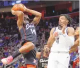  ?? DUANE BURLESON / ASSOCIATED PRESS ?? Detroit guard Alec Burks (14) goes to the basket against Brooklyn guard Dennis Smith Jr. (4) during Tuesday’s game in Detroit.