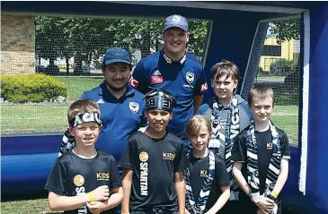  ??  ?? Melbourne Victory community coaches Ron Wilson and Aiden Brown (back) with participan­ts (front, from left) Eli Parktni, Isaac Kenny, Emma Timewell and Louis Devlin.
