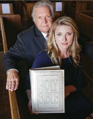  ??  ?? Robert “Dick” Tips, owner of Mission Park Funeral Chapels, and his wife, Kristin, the company’s president, COO and funeral director, display a family Bible.