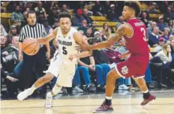  ?? Jeremy Papasso, Daily Camera ?? CU sophomore guard Deleon Brown dribbles past DU freshman Elvin Rodriguez on Tuesday night.