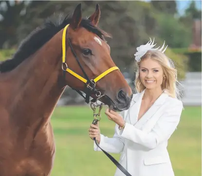  ??  ?? GOOD CHANCE: Model Elyse Knowles with one of the Derby Day favourites Home Ground, who will be ridden by Winx jockey Hugh Bowman.