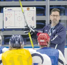  ?? GORD WALDNER ?? Saskatoon Blades head coach Dean Brockman talks to his players during an afternoon session on the ice Thursday.