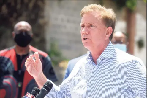  ?? Ned Gerard / Hearst Connecticu­t Media ?? Gov. Ned Lamont speaks during a news conference next to a mobile COVID-19 testing site outside Mount Aery Church in Bridgeport on June 26.
