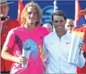  ??  ?? Rafael Nadal (R) of Spain with the champions trophy after his win in the final against Stefanos Tsitsipas (L)