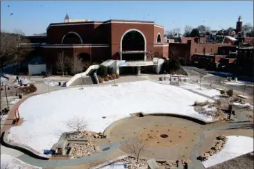  ??  ?? ABOVE: Snow covers parts of the Town Green on Wednesday following a winter storm.