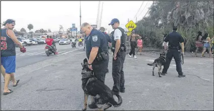  ?? MATT KEMPNER PHOTOS / AJC ?? Police and sheriff’s deputies are out in force in Panama City Beach during college spring break weeks In March this year, as the city attempts to avoid the troubles it faced in 2015.