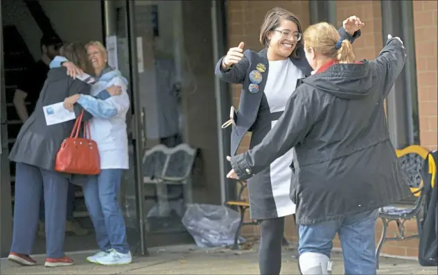  ?? Pam Panchak/Post-Gazette ?? The Democratic candidate for the 21st state House District, Sara Innamorato, greets voters at St. Teresa of Avila Church in Ross.