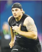  ?? Charlie Neibergall / Associated Press ?? Oregon offensive lineman Shane Lemieux runs a drill at the NFL scouting combine.