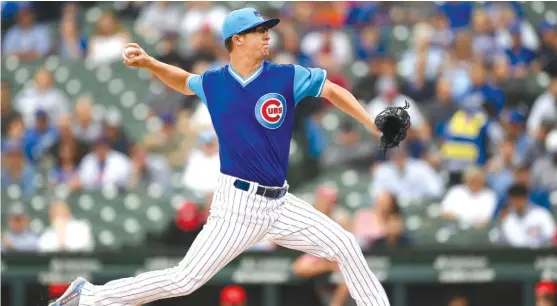  ?? STACY REVERE/GETTY IMAGES ?? Alec Mills, making his first major-league start, throws a pitch in the first inning Friday. He also got his first hit in the third inning off Matt Harvey.