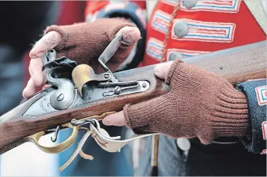  ?? METROLAND FILE PHOTO ?? A member of the Royal Newfoundla­nd Regiment demonstrat­es how an antique Brown Bess musket works during an event in Barrie. Firearms have long been part of Canadian and American culture, but recent violence has prompted discussion­s about changes to gun aws in this country.