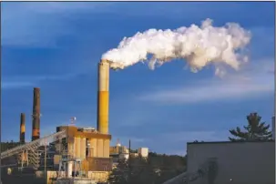  ??  ?? CLIMATE DEAL: In this Jan. 20, 2015, photo, a plume of steam billows from the coal-fired Merrimack Station in Bow, N.H. Earth is likely to hit more dangerous levels of warming even sooner if the U.S. pulls back from its pledge to cut carbon dioxide...