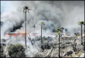  ?? DAVID BAUMAN/THE PRESS-ENTERPRISE VIA AP ?? Several hilltop homes burn Saturday in San Bernardino, Calif., after a fast-moving brush fire. Five homes were burned and several people, including three firefighte­rs, were injured in the blaze.